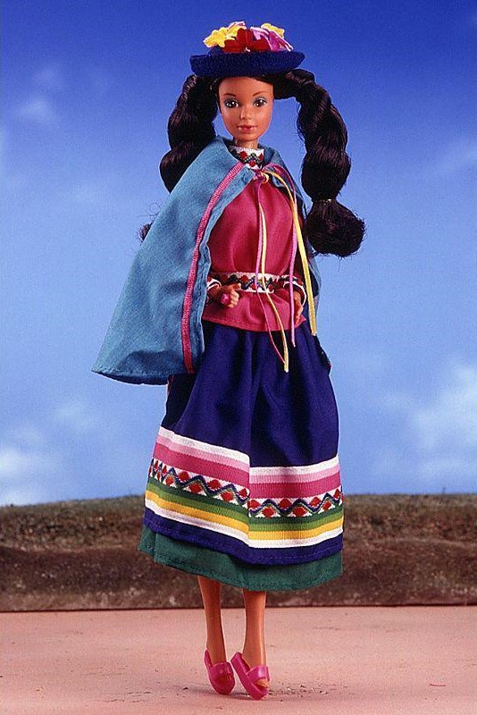 1986 doll dressed in traditional Peruvian attire, with a patterned skirt, shawl, and two thick braids